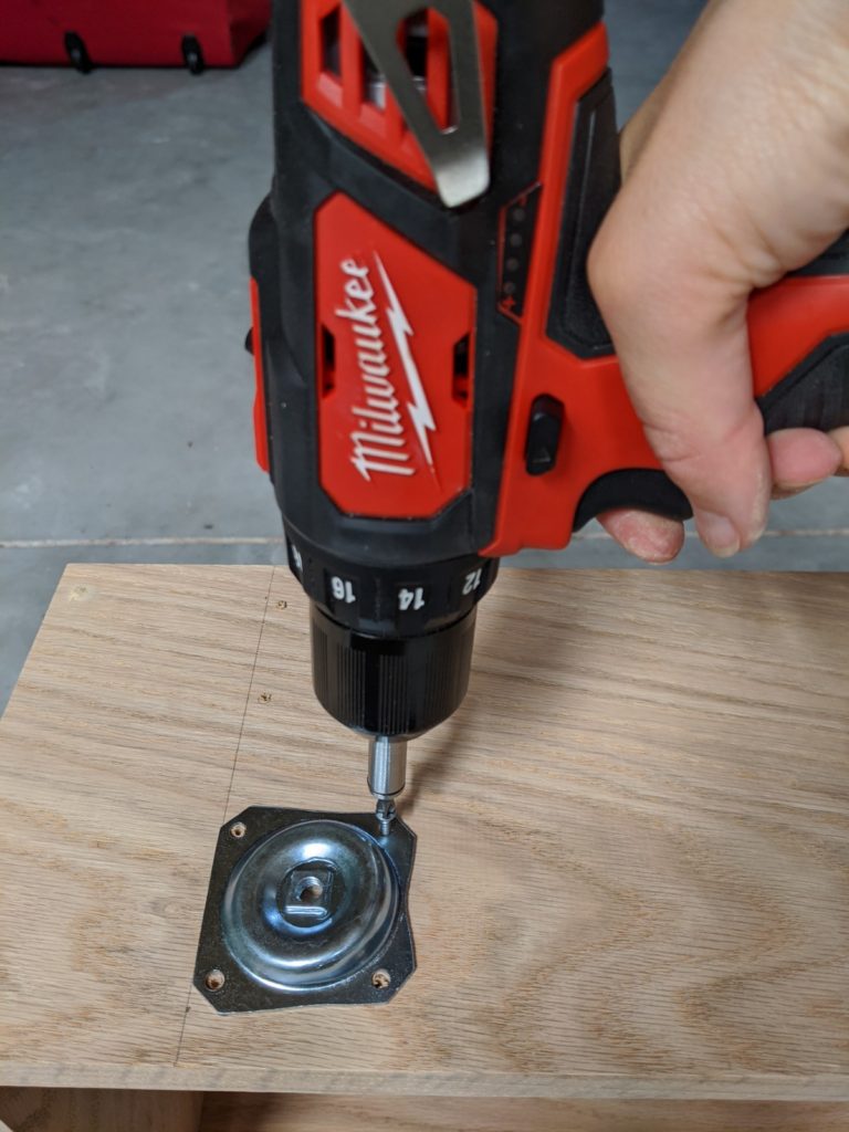 Installing the angled leg mounting plates to the bottom of the console table