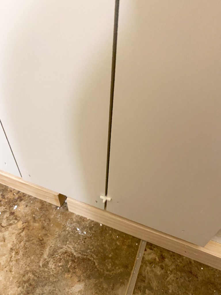 Using tile spacers to create a gap between boards to appear like shiplap