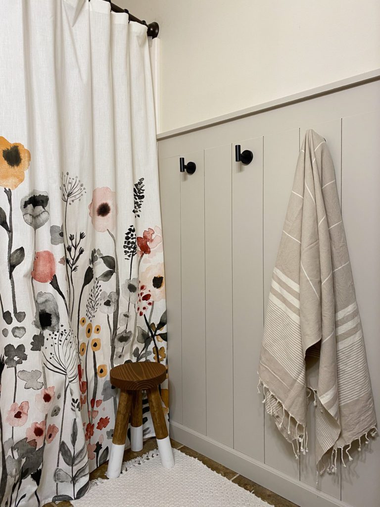 Finished Vertical Shiplap Wall in Bathroom with Floral Curtain